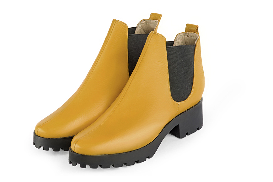Mustard yellow and matt black women's ankle boots, with elastics. Round toe. Low rubber soles. Front view - Florence KOOIJMAN